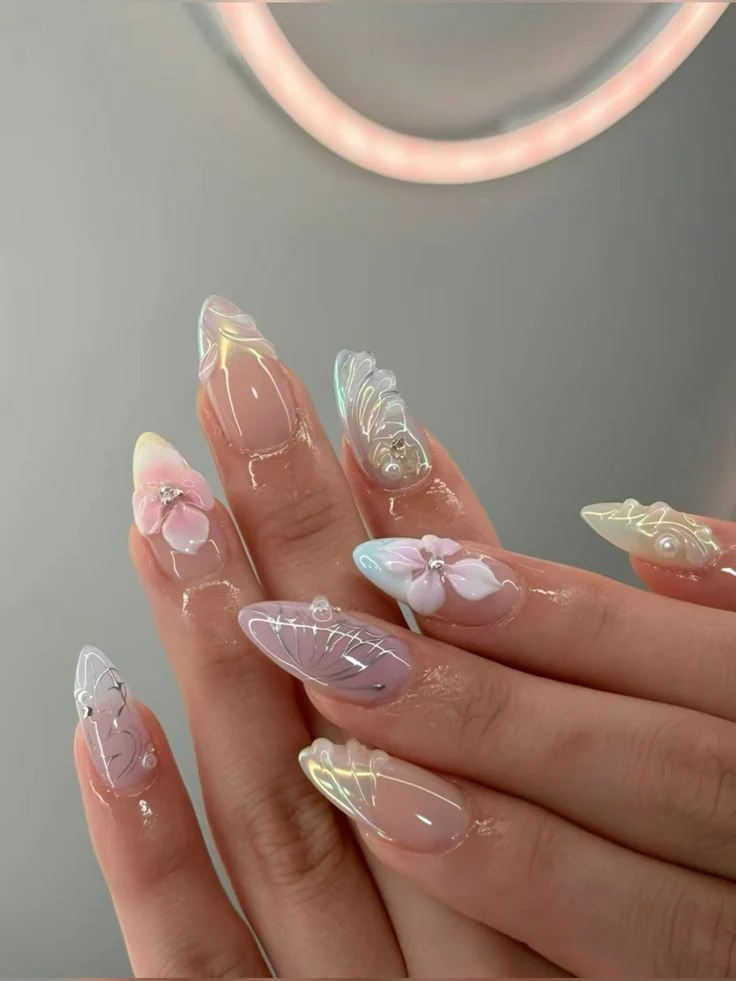 Summer floral nails with bright tropical flowers - vibrant hand showcasing colorful base with bright tropical flower petals, featuring green leaves and stems on almond-shaped nails
